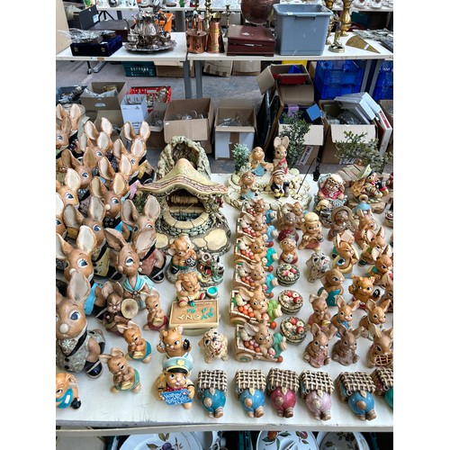 518 - An extensive collection of Pendelfin rabbit figurines and display stands to include Daisy Duck, Coll... 