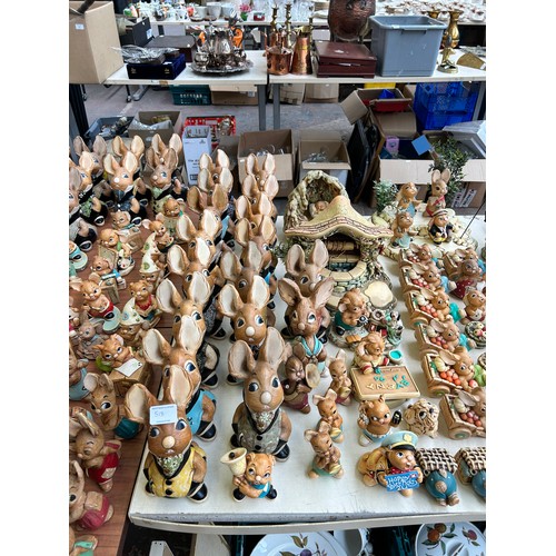 518 - An extensive collection of Pendelfin rabbit figurines and display stands to include Daisy Duck, Coll... 