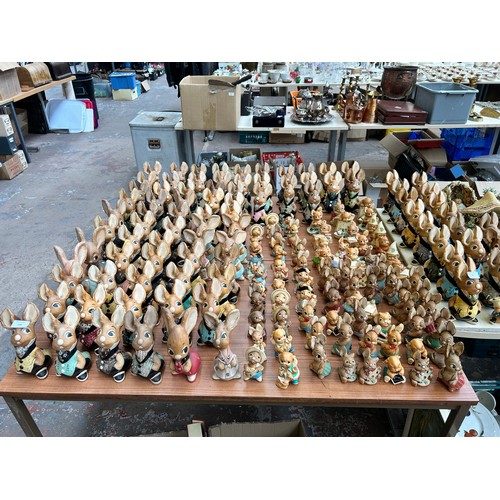 518 - An extensive collection of Pendelfin rabbit figurines and display stands to include Daisy Duck, Coll... 