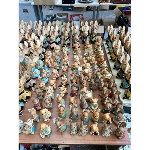 518 - An extensive collection of Pendelfin rabbit figurines and display stands to include Daisy Duck, Coll... 