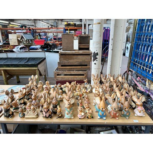 518 - An extensive collection of Pendelfin rabbit figurines and display stands to include Daisy Duck, Coll... 