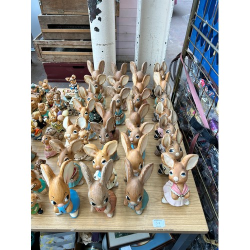 518 - An extensive collection of Pendelfin rabbit figurines and display stands to include Daisy Duck, Coll... 