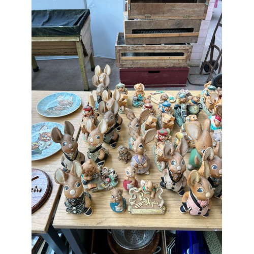 518 - An extensive collection of Pendelfin rabbit figurines and display stands to include Daisy Duck, Coll... 