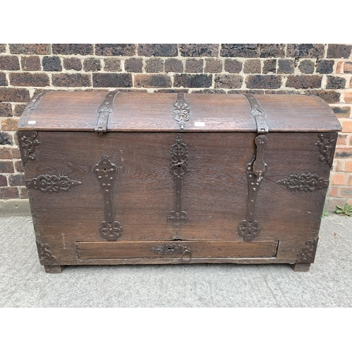 9 - A large 18th century German oak and metal banded dome top seaman's chest with lower drawer - approx.... 