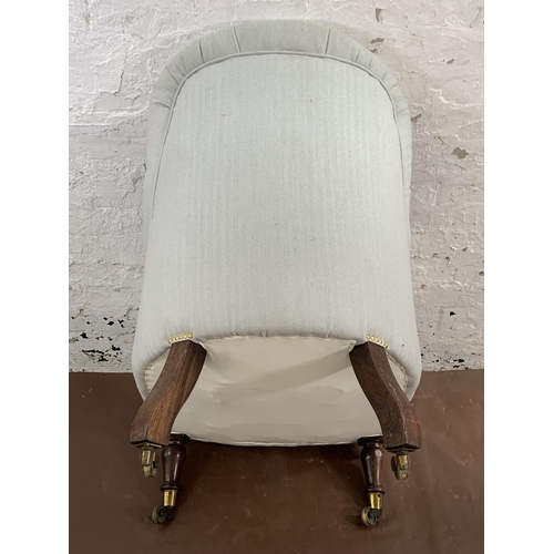 74 - A Victorian Saville Row blue and white fabric upholstered button back armchair on rosewood supports ... 