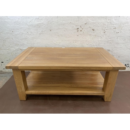 97 - A modern solid oak rectangular two tier coffee table - approx. 50cm high x 70cm wide x 120cm long