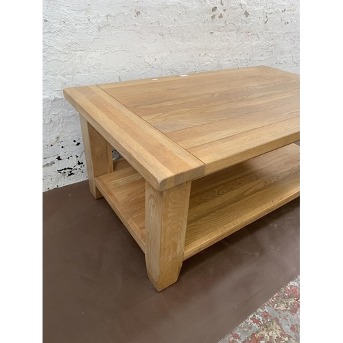 97 - A modern solid oak rectangular two tier coffee table - approx. 50cm high x 70cm wide x 120cm long