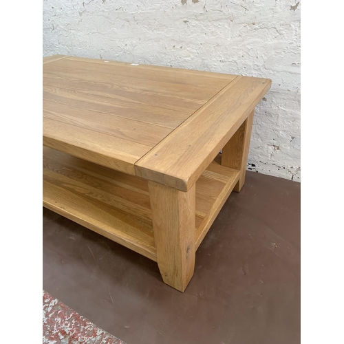 97 - A modern solid oak rectangular two tier coffee table - approx. 50cm high x 70cm wide x 120cm long