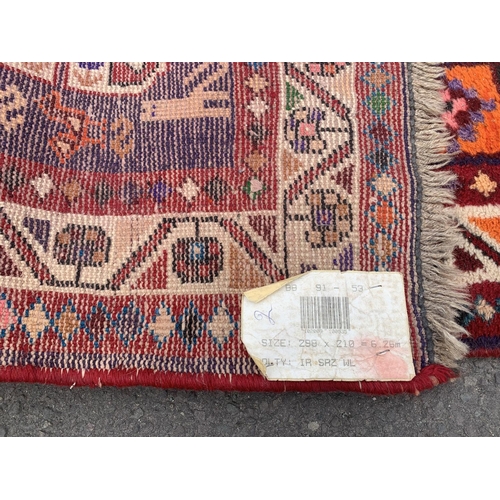 135 - A 20th century machine woven Shiraz rug - approx. 298cm x 210cm