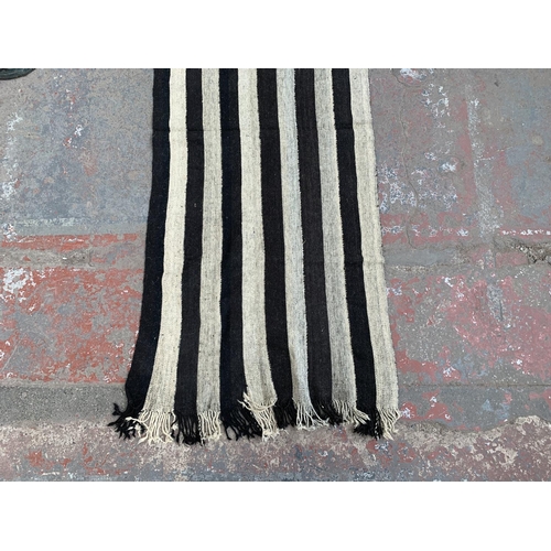 108 - A mid 20th century black and white Kilim hall runner/rug - approx. 245cm x 95cm