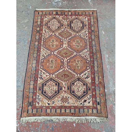 192 - An antique Persian hand knotted rug - approx. 200cm x 118cm