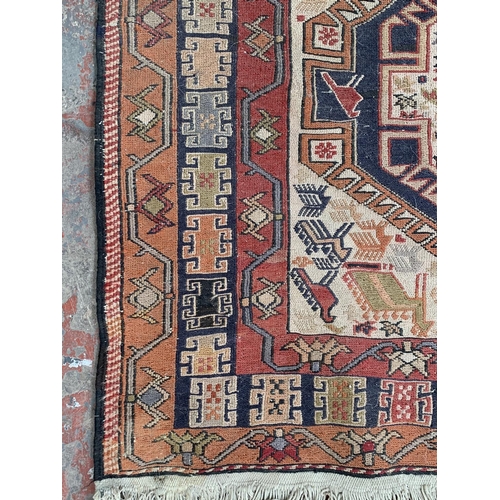 192 - An antique Persian hand knotted rug - approx. 200cm x 118cm