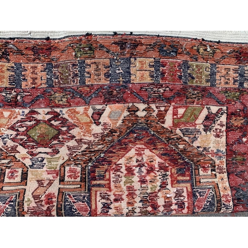 192 - An antique Persian hand knotted rug - approx. 200cm x 118cm