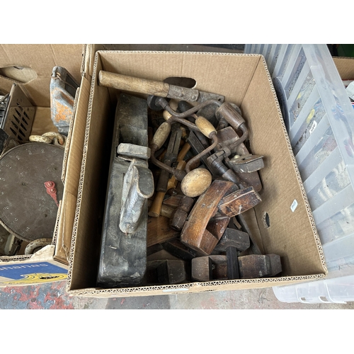 1050 - Two boxes containing antique wood planes, hand drills, chisels etc.