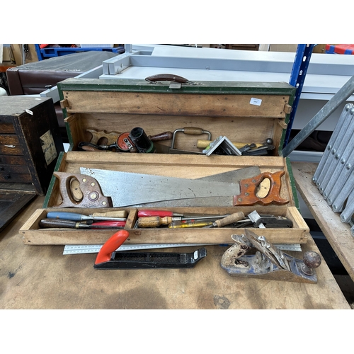 1051 - A vintage carpenter’s tool chest containing Spear & Jackson hand saws, Stanley hand drill, Record no... 