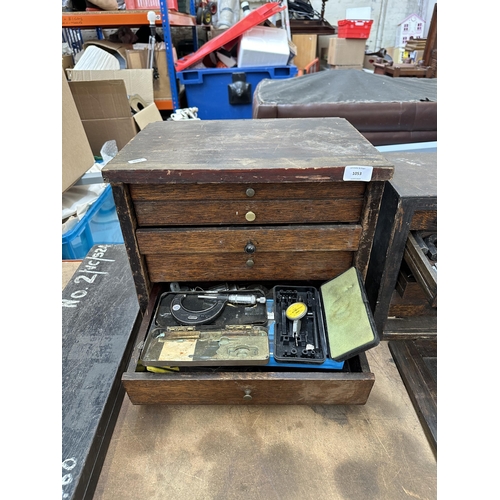 1053 - An early 20th century oak engineer's tool cabinet containing Moore & Wright callipers, tap and die s... 