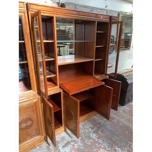 11 - A Chinese carved hardwood four piece display unit - approx. 320cm wide x 109cm high x 45.5cm deep