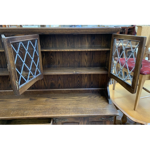 111 - A carved oak dresser - approx. 161cm high x 186cm wide x 42.5cm deep