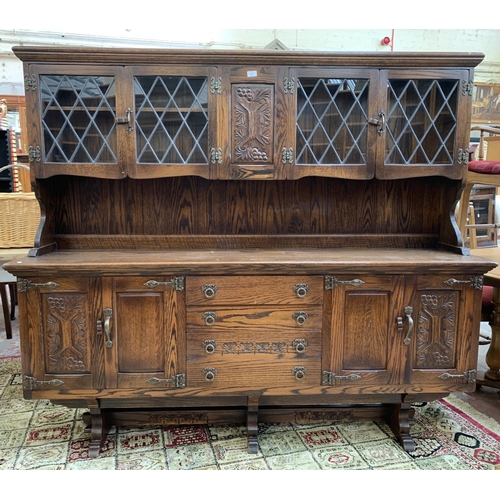 111 - A carved oak dresser - approx. 161cm high x 186cm wide x 42.5cm deep