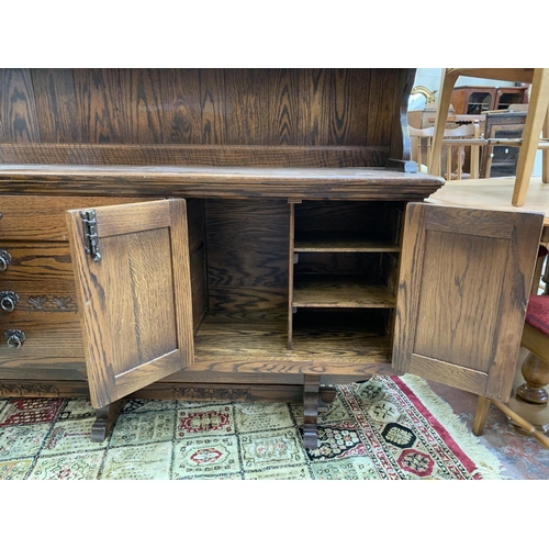 111 - A carved oak dresser - approx. 161cm high x 186cm wide x 42.5cm deep