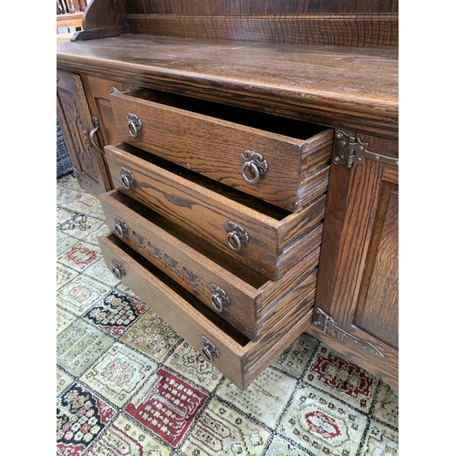 111 - A carved oak dresser - approx. 161cm high x 186cm wide x 42.5cm deep