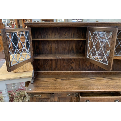 111 - A carved oak dresser - approx. 161cm high x 186cm wide x 42.5cm deep