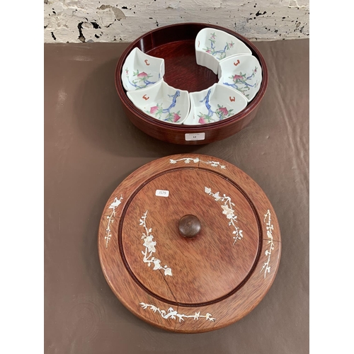 12 - A Chinese hardwood and mother of pearl inlaid lazy susan with five hand painted ceramic snack dishes... 