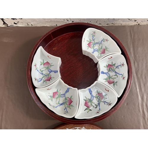 12 - A Chinese hardwood and mother of pearl inlaid lazy susan with five hand painted ceramic snack dishes... 