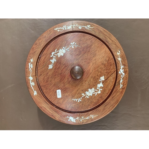 12 - A Chinese hardwood and mother of pearl inlaid lazy susan with five hand painted ceramic snack dishes... 