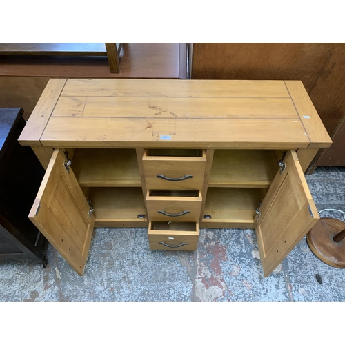 127 - A modern pine sideboard with three drawers and two cupboard doors - approx. 76cm high x 115cm wide x... 