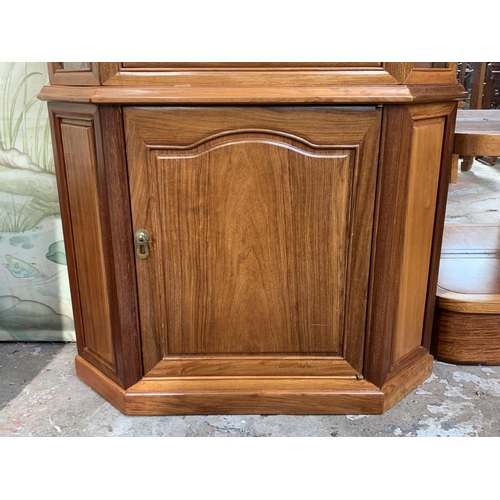 13 - A Chinese carved hardwood free standing corner cabinet - approx. 198cm high