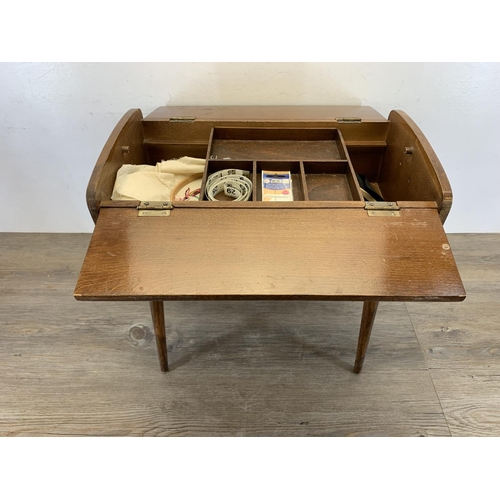 138 - A mid 20th century walnut sewing box on tapered supports - approx. 45cm high x 46.5cm wide x 27cm de... 