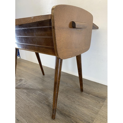 138 - A mid 20th century walnut sewing box on tapered supports - approx. 45cm high x 46.5cm wide x 27cm de... 