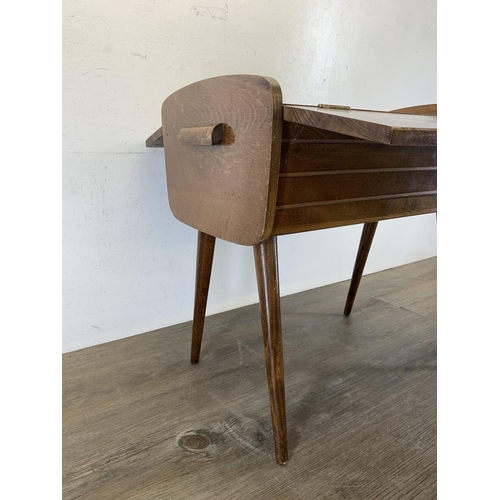 138 - A mid 20th century walnut sewing box on tapered supports - approx. 45cm high x 46.5cm wide x 27cm de... 