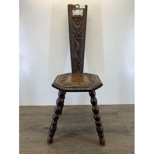 141 - A vintage carved oak spinning chair - approx. 87cm high