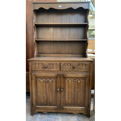 143 - A carved oak Priory style dresser - approx. 178cm high x 95cm wide x 44cm deep