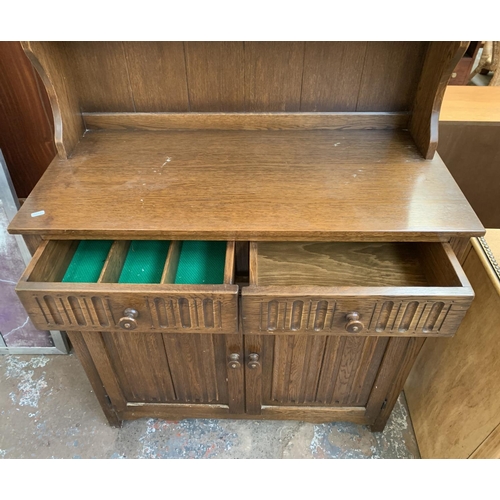 143 - A carved oak Priory style dresser - approx. 178cm high x 95cm wide x 44cm deep