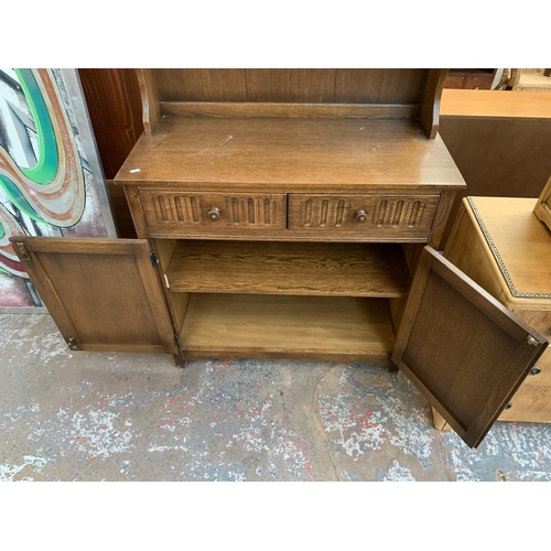 143 - A carved oak Priory style dresser - approx. 178cm high x 95cm wide x 44cm deep