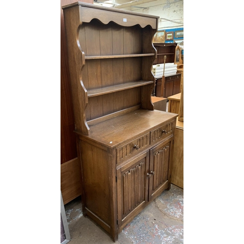 143 - A carved oak Priory style dresser - approx. 178cm high x 95cm wide x 44cm deep