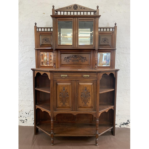 2 - An Edwardian mahogany mirrored back display cabinet with five shelves, two carved panel doors, one d... 