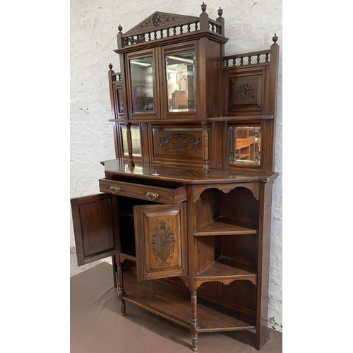 2 - An Edwardian mahogany mirrored back display cabinet with five shelves, two carved panel doors, one d... 