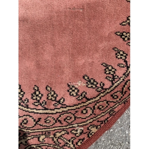 204 - A red circular rug