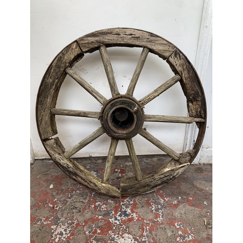 28 - An antique wooden and wrought iron cartwheel - approx. 68cm in diameter