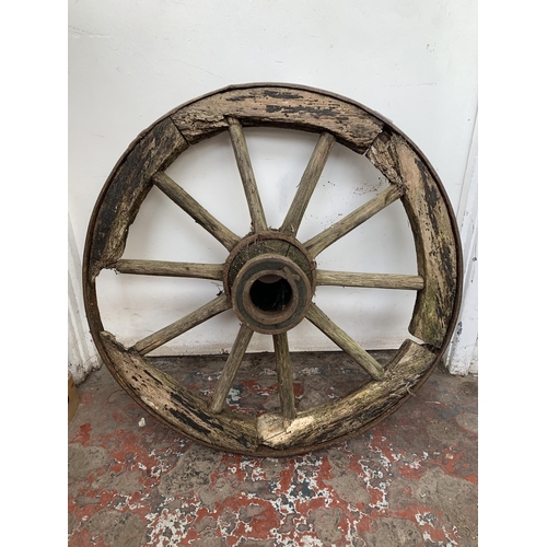 28 - An antique wooden and wrought iron cartwheel - approx. 68cm in diameter