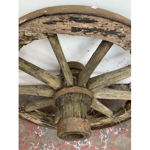 28 - An antique wooden and wrought iron cartwheel - approx. 68cm in diameter