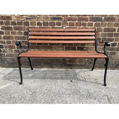 39 - A cast iron and wooden slatted garden bench - approx. 80cm high x 126cm wide x 44cm deep