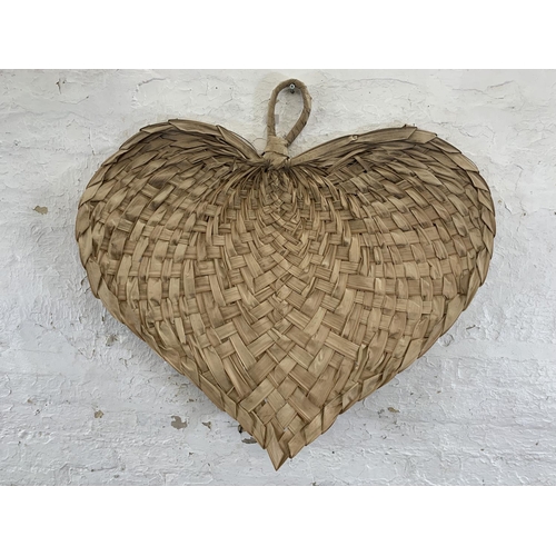 4 - A contemporary woven palm leaf heart shaped wall hanging - approx. 84cm high x 92cm wide