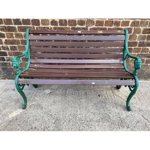 43 - A cast iron and wooden slatted garden bench - approx. 81cm high x 126cm wide x 46.5cm deep