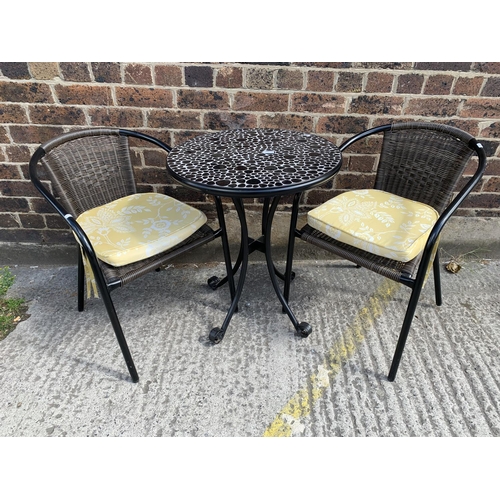 44 - A modern black metal and resin topped patio table with two chairs - table approx. 73cm high x 61cm i... 