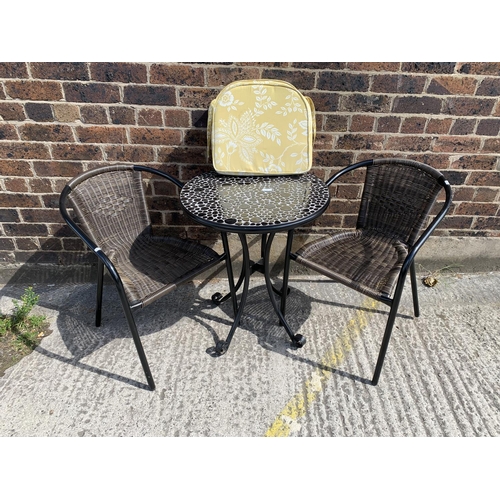 44 - A modern black metal and resin topped patio table with two chairs - table approx. 73cm high x 61cm i... 